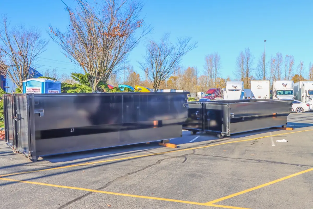 Professional dumpster rental service with roll-off container on residential driveway in Moundsville
